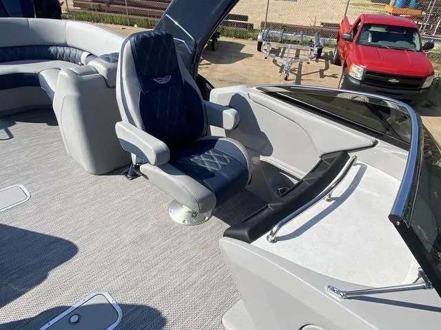 Slide: The Image of 2023 Bennington 30 QXSBWA X2 boat interior with captain's chair and seating area. - 13