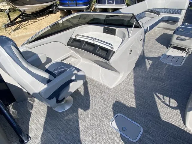 Slide: The Image of 2023 Bennington 30 QXSBWA X2 boat interior with sleek seating and modern dashboard. - 14