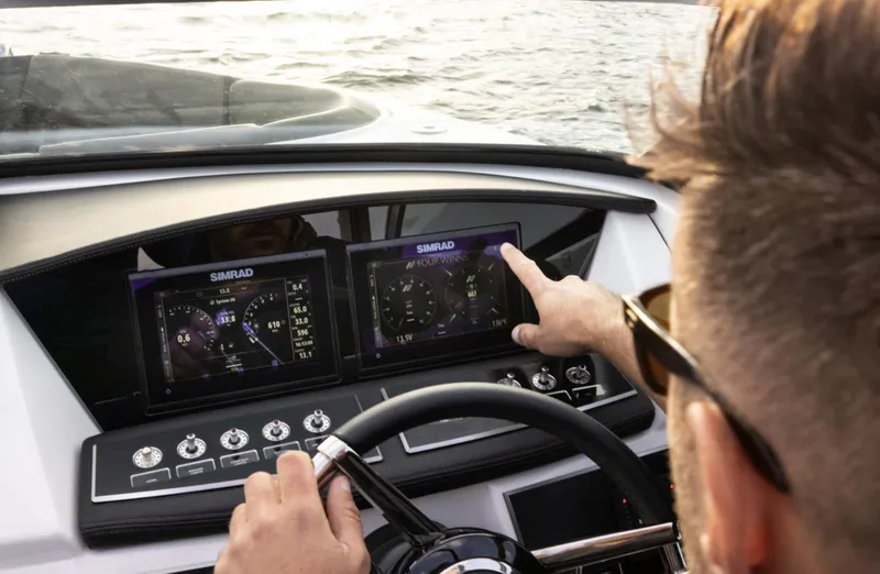 Slide: The Image of Man operating 2018 Four Winns HD240 OB boat with Simrad navigation system. - 14