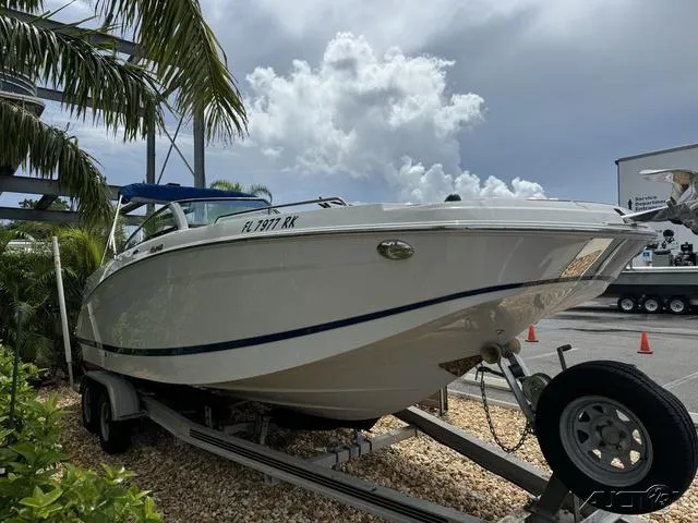 Slide: The Image of 2018 Four Winns HD240 OB boat on trailer, parked outdoors under cloudy sky. - 4