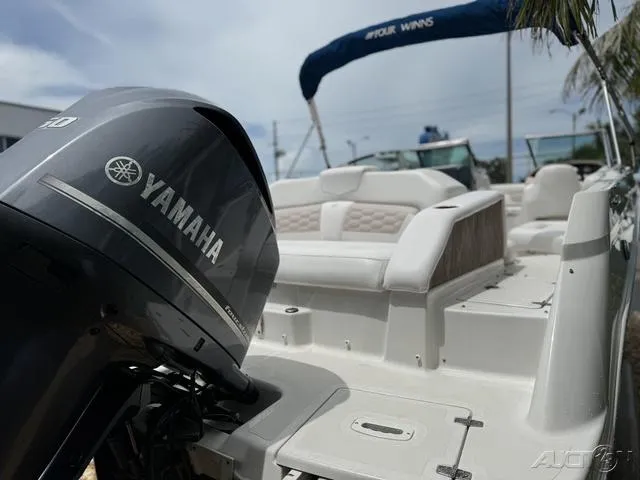Slide: The Image of 2018 Four Winns HD240 OB boat with Yamaha outboard motor, featuring spacious seating and canopy. - 6