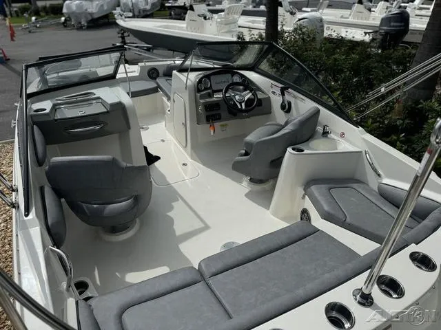 Slide: The Image of 2021 Stingray 201DS boat interior with gray seating and modern dashboard. - 10