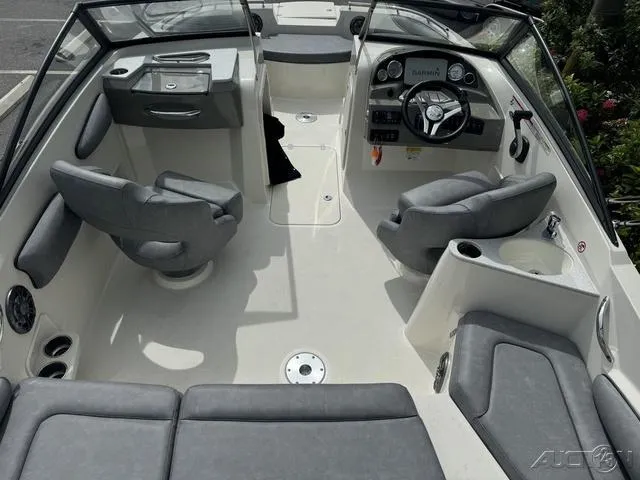 Slide: The Image of 2021 Stingray 201DS boat interior with gray seating and modern dashboard. - 11