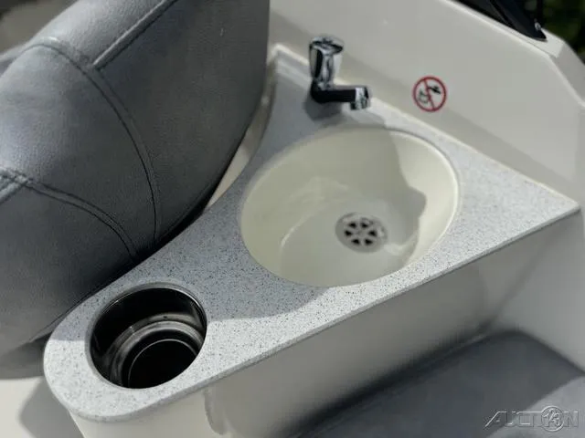 Slide: The Image of 2021 Stingray 201DS boat sink and cup holder detail. - 13