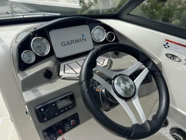 Slide: The Image of 2021 Stingray 201DS boat dashboard with Garmin navigation system and steering wheel. - 15