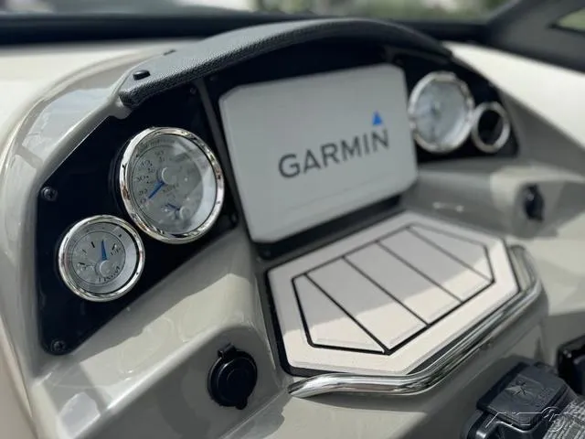 Slide: The Image of 2021 Stingray 201DS dashboard with Garmin display and gauges. - 16
