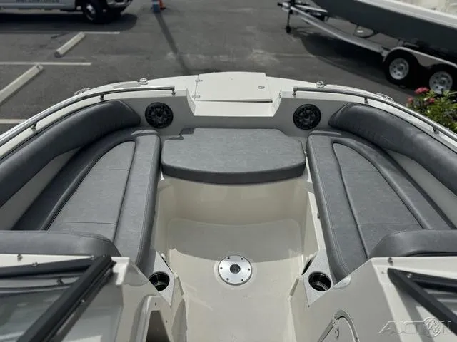 Slide: The Image of 2021 Stingray 201DS boat interior with gray seating and speakers. - 17