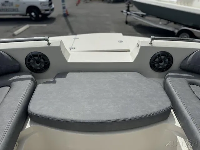 Slide: The Image of 2021 Stingray 201DS boat interior with cushioned seating and speakers. - 18