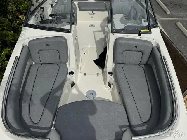 Slide: The Image of 2021 Stingray 201DS boat interior with gray seating and open deck layout. - 19