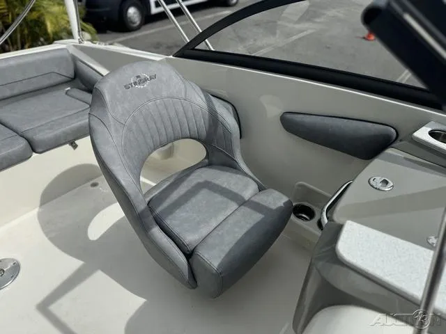 Slide: The Image of 2021 Stingray 201DS boat interior with gray seating and modern design. - 22