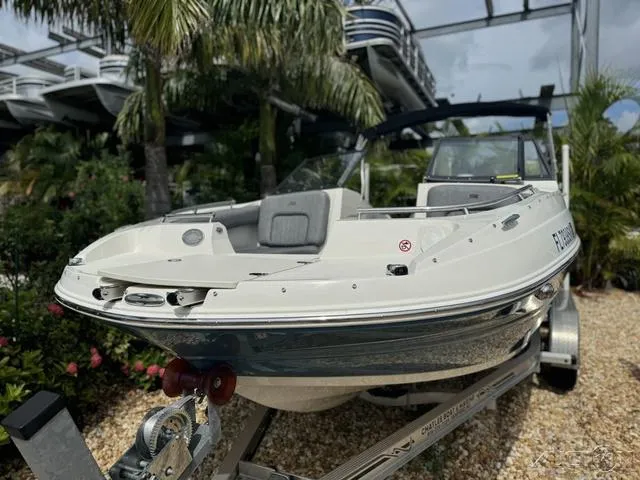 Slide: The Image of 2021 Stingray 201DS boat on trailer, surrounded by tropical plants. - 3