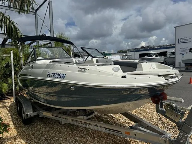 Slide: The Image of 2021 Stingray 201DS boat on trailer, parked outdoors under cloudy sky. - 5