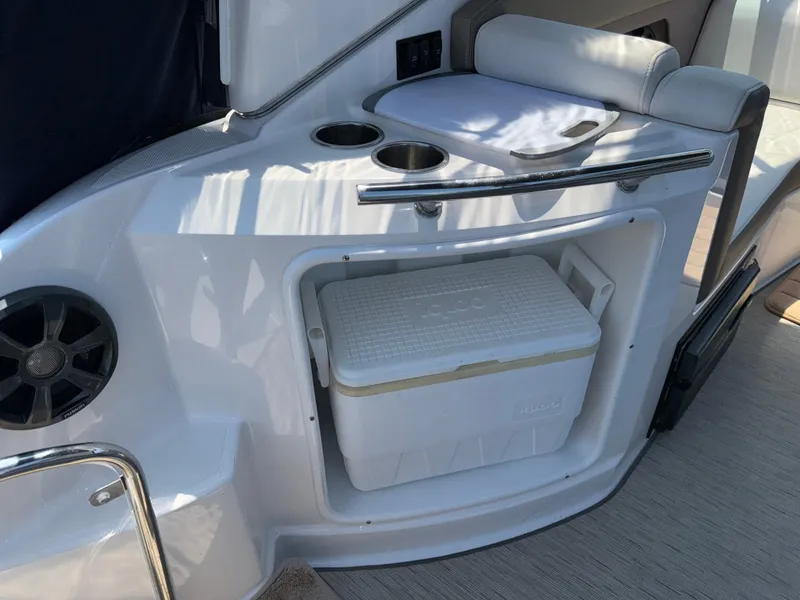 Slide: The Image of 2017 Regal 28 Express boat interior with cooler storage and cup holders. - 21