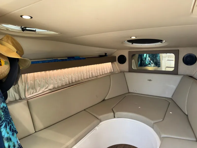 Slide: The Image of Interior of 2017 Regal 28 Express boat with beige seating and circular table. - 41