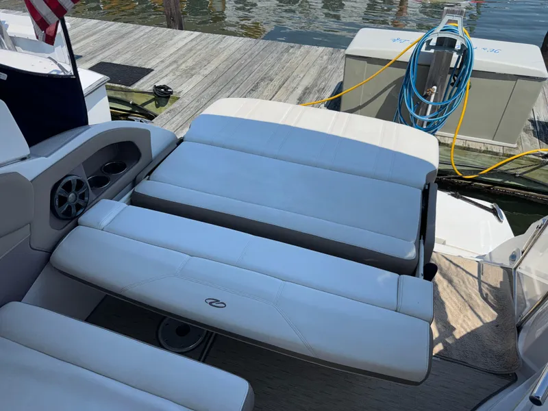 Slide: The Image of 2017 Regal 28 Express boat interior with white seating, dockside view. - 20