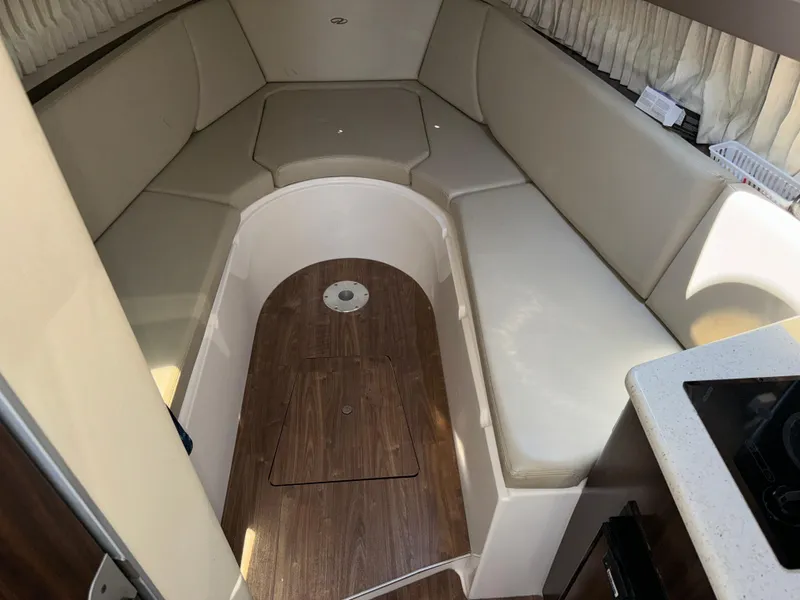 Slide: The Image of 2017 Regal 28 Express cabin interior with beige seating and wood flooring. - 38