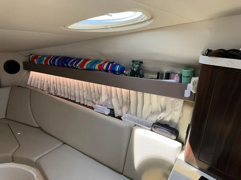 Slide: The Image of Interior of 2017 Regal 28 Express boat with seating and storage shelf. - 42