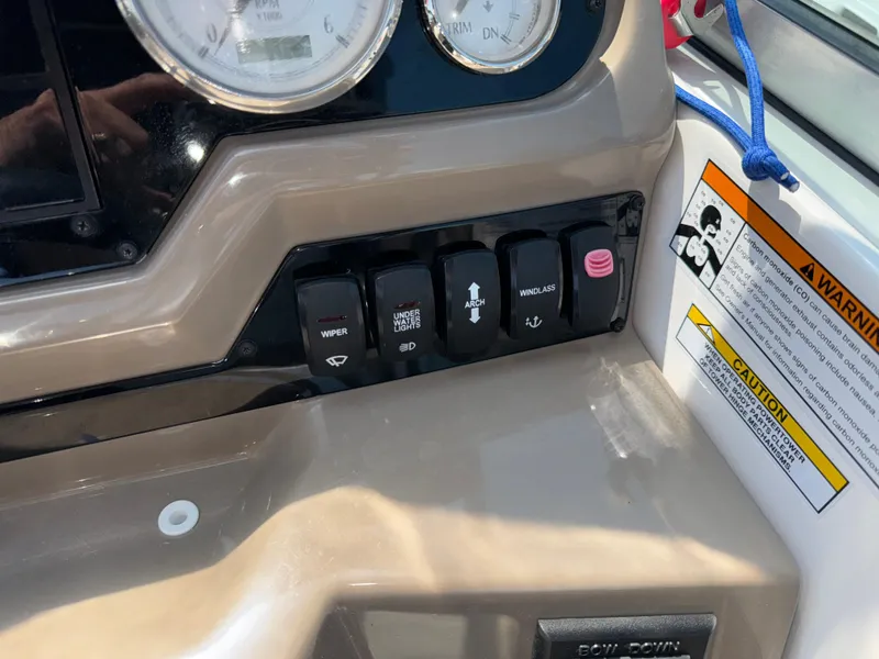 Slide: The Image of Control panel of 2017 Regal 28 Express boat with switches and warning label. - 35