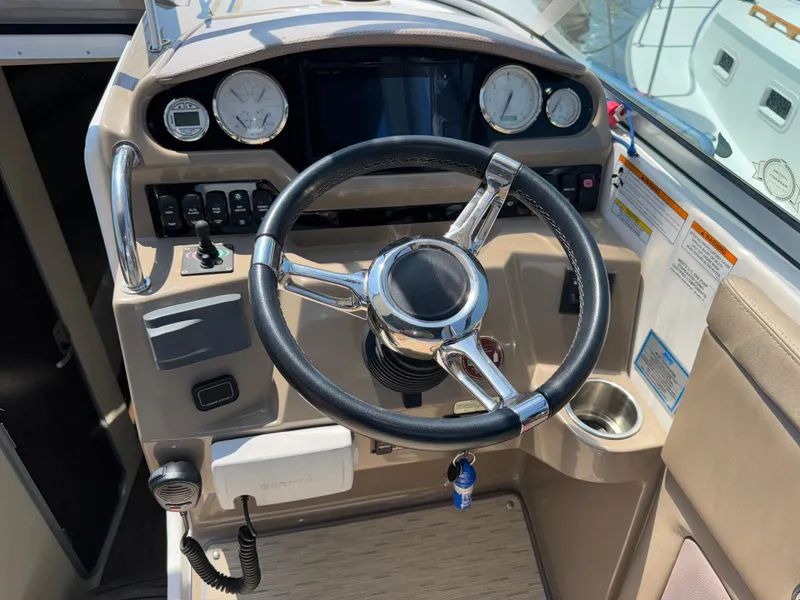 Slide: The Image of 2017 Regal 28 Express boat cockpit with steering wheel and dashboard controls. - 27
