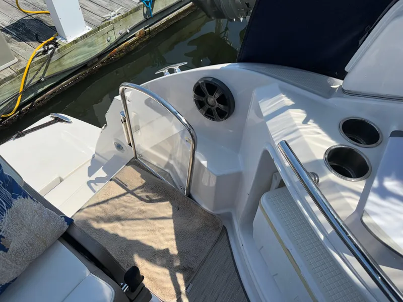 Slide: The Image of 2017 Regal 28 Express boat interior with seating, cup holders, and dock view. - 23