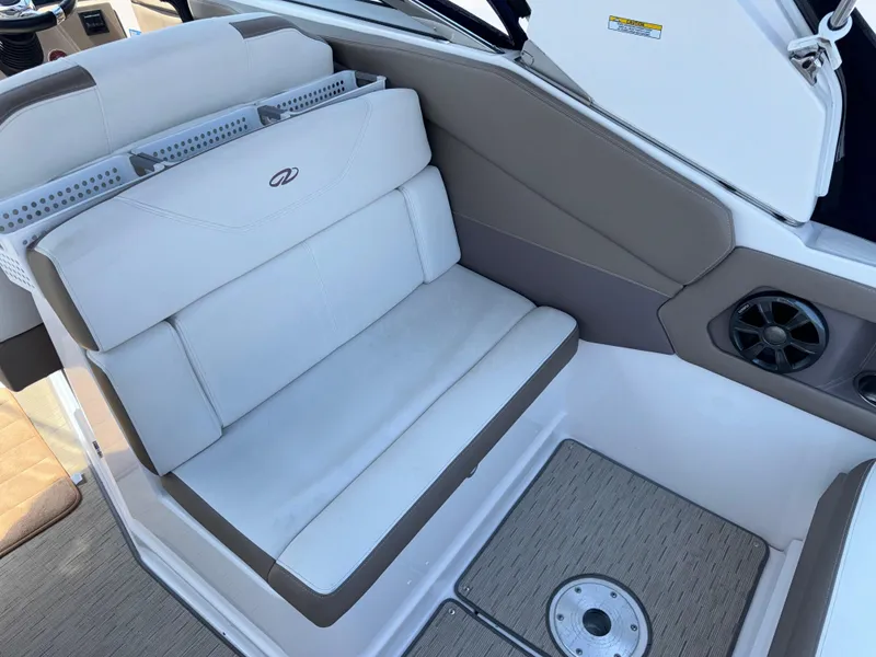 Slide: The Image of 2017 Regal 28 Express boat interior seating with beige and white upholstery. - 18
