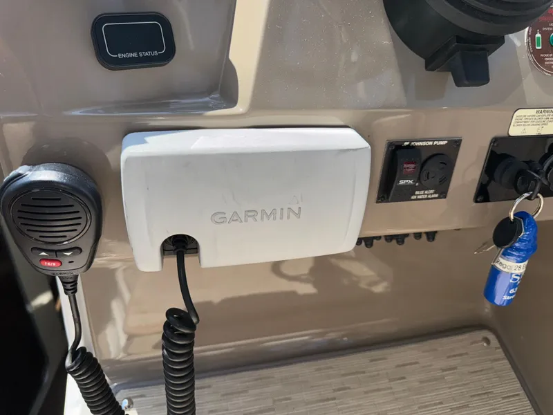 Slide: The Image of 2017 Regal 28 Express dashboard with Garmin device and controls. - 32
