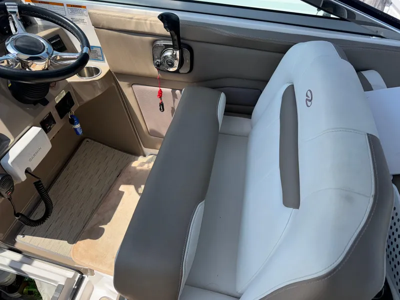 Slide: The Image of Interior of 2017 Regal 28 Express boat with steering wheel and seating. - 26