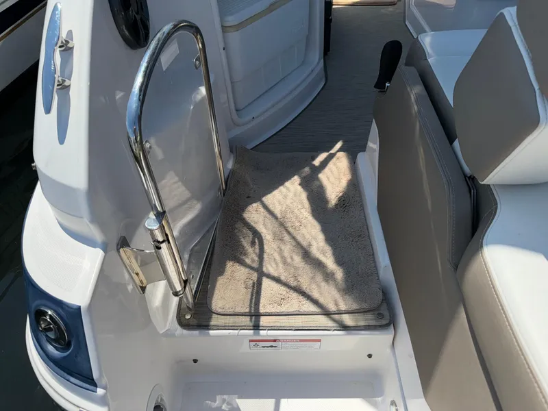 Slide: The Image of 2017 Regal 28 Express boat interior with carpeted step and seating area. - 22