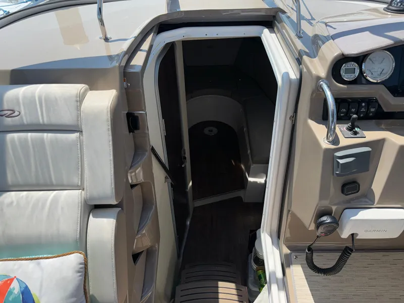 Slide: The Image of 2017 Regal 28 Express boat interior with open cabin door and dashboard view. - 37