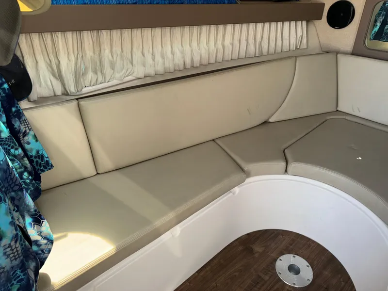 Slide: The Image of 2017 Regal 28 Express boat interior with beige seating and wood flooring. - 40