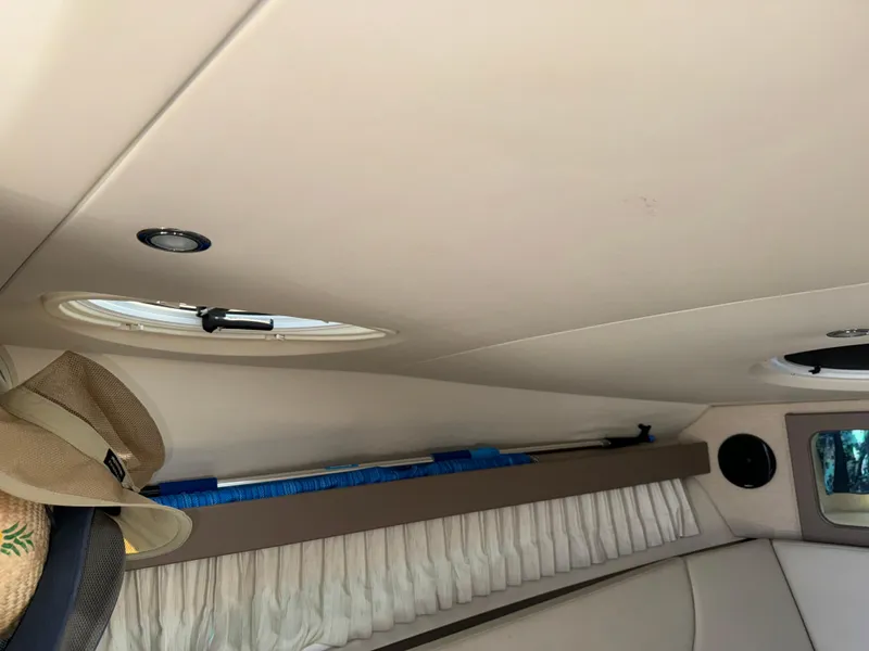 Slide: The Image of Interior of 2017 Regal 28 Express boat with hats and window. - 43