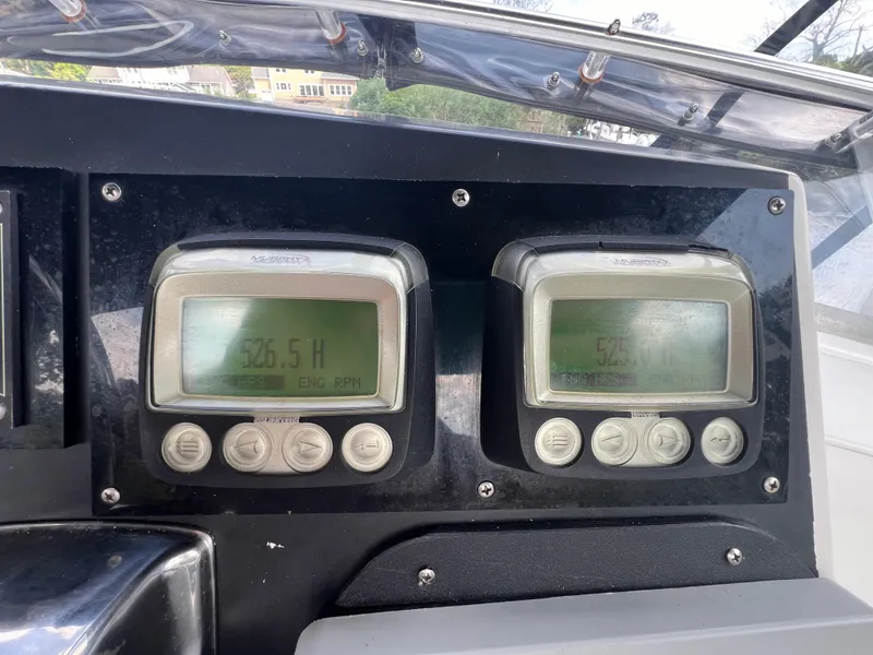 Slide: The Image of Digital gauges on a 1990 Bertram 28 Flybridge boat dashboard. - 18