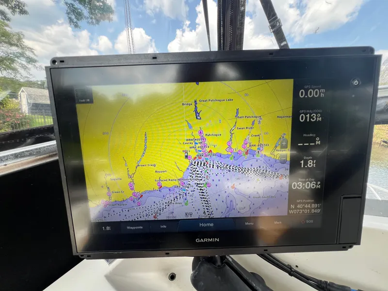 Slide: The Image of Garmin navigation display on a 1990 Bertram 28 Flybridge boat, showing a detailed nautical map. - 22