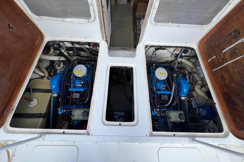 Slide: The Image of Engine compartment of a 1990 Bertram 28 Flybridge with dual blue engines. - 36