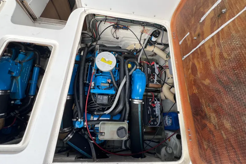 Slide: The Image of Engine compartment of a 1990 Bertram 28 Flybridge boat, showcasing detailed mechanical components. - 39