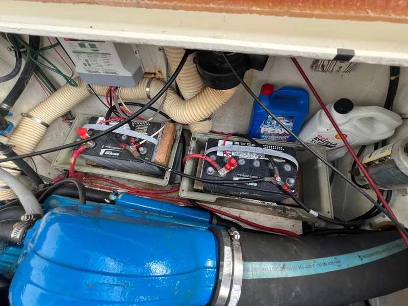 Slide: The Image of Engine compartment of 1990 Bertram 28 Flybridge with batteries and maintenance supplies. - 41