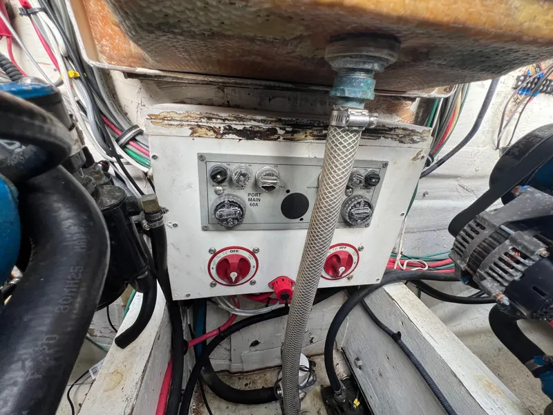 Slide: The Image of Control panel in a 1990 Bertram 28 Flybridge engine room with wiring and gauges. - 43