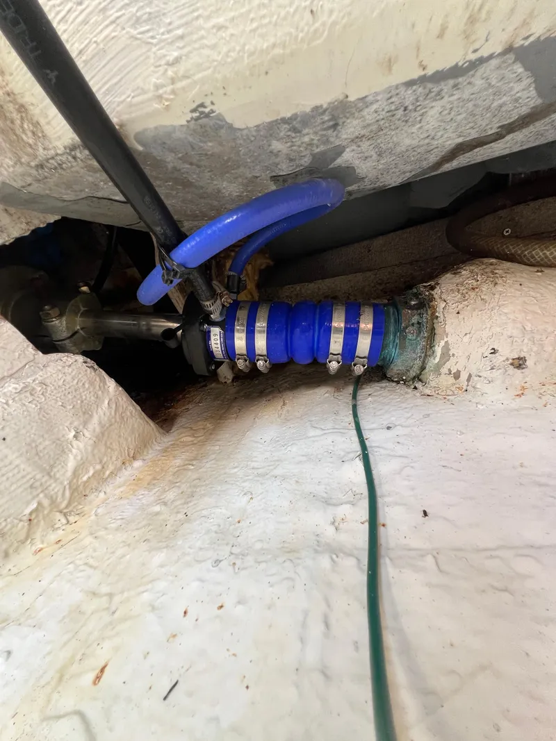 Slide: The Image of Bilge area of a 1990 Bertram 28 Flybridge with blue hose and valve. - 45