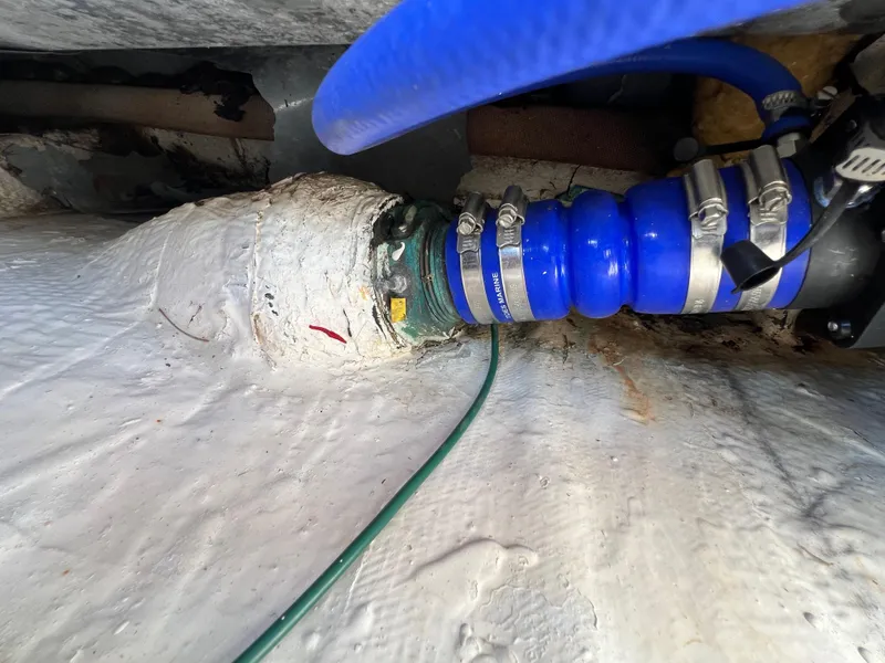 Slide: The Image of Engine compartment of a 1990 Bertram 28 Flybridge with blue hose and clamps. - 46