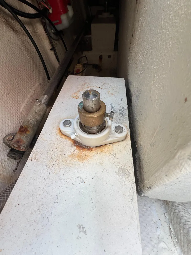 Slide: The Image of Boat engine component in a 1990 Bertram 28 Flybridge, showing wear and rust. - 47