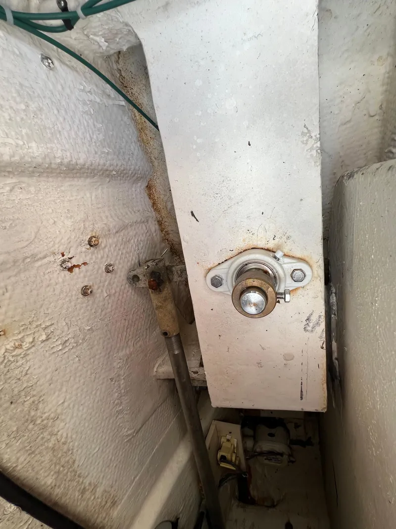 Slide: The Image of 1990 Bertram 28 Flybridge interior detail showing mechanical components and wiring. - 48