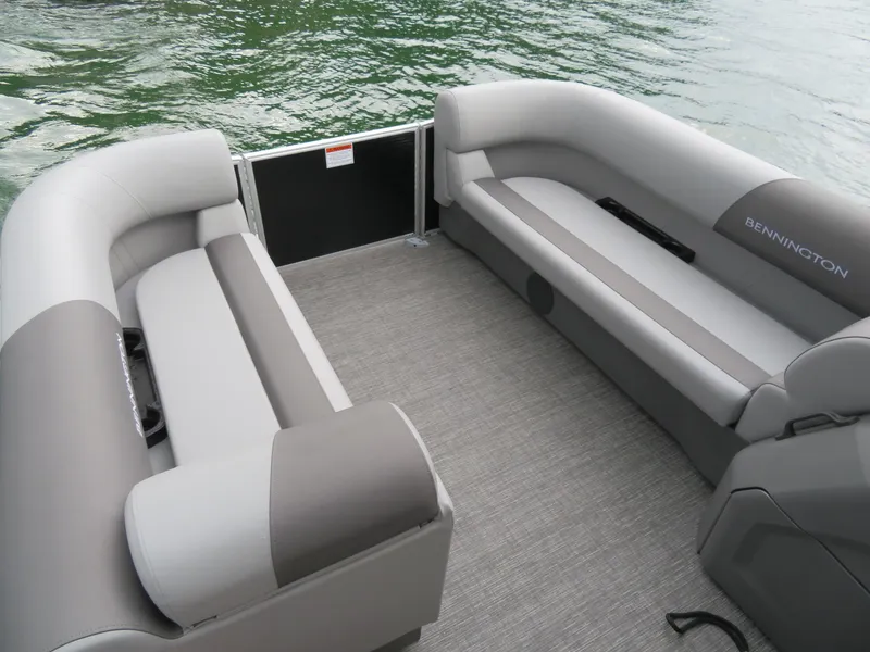 Slide: The Image of 2025 Bennington 20SVL-SPS pontoon boat interior with gray seating and water view. - 10