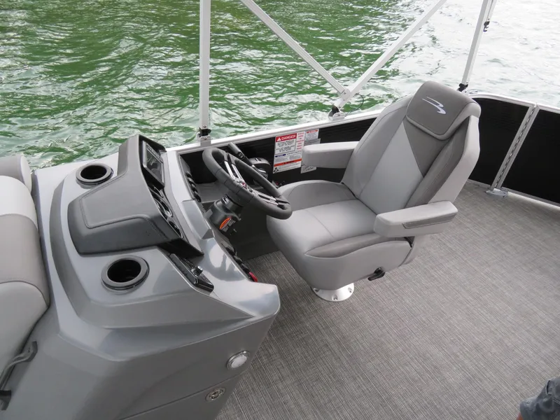 Slide: The Image of 2025 Bennington 20SVL-SPS boat interior with steering console and captain's chair on water. - 12