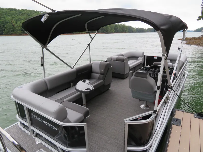Slide: The Image of 2025 Bennington 20SVL-SPS pontoon boat with canopy on a serene lake. - 17