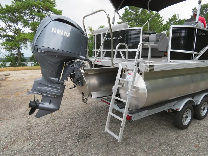 Slide: The Image of 2025 Bennington 20SVL-SPS pontoon boat with Yamaha outboard motor on trailer. - 3