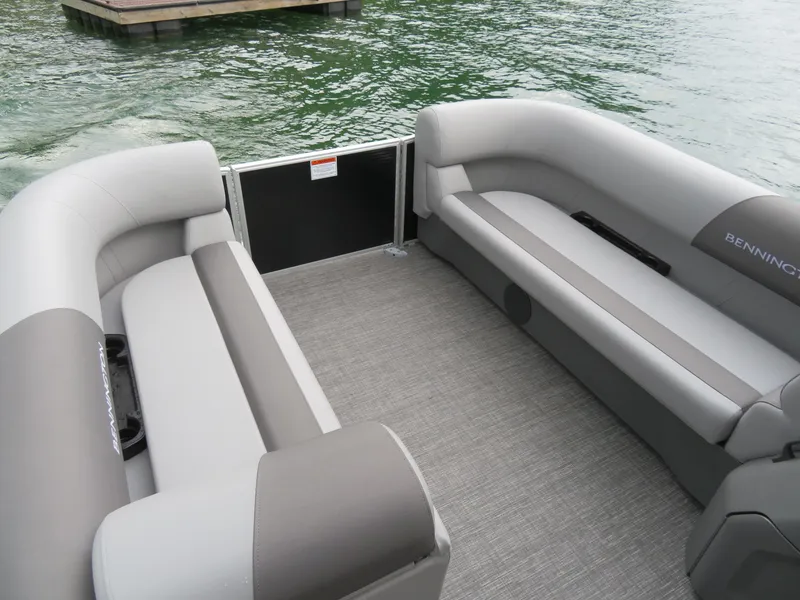 Slide: The Image of 2025 Bennington 20SVL-SPS pontoon boat interior with gray seating and lake view. - 9