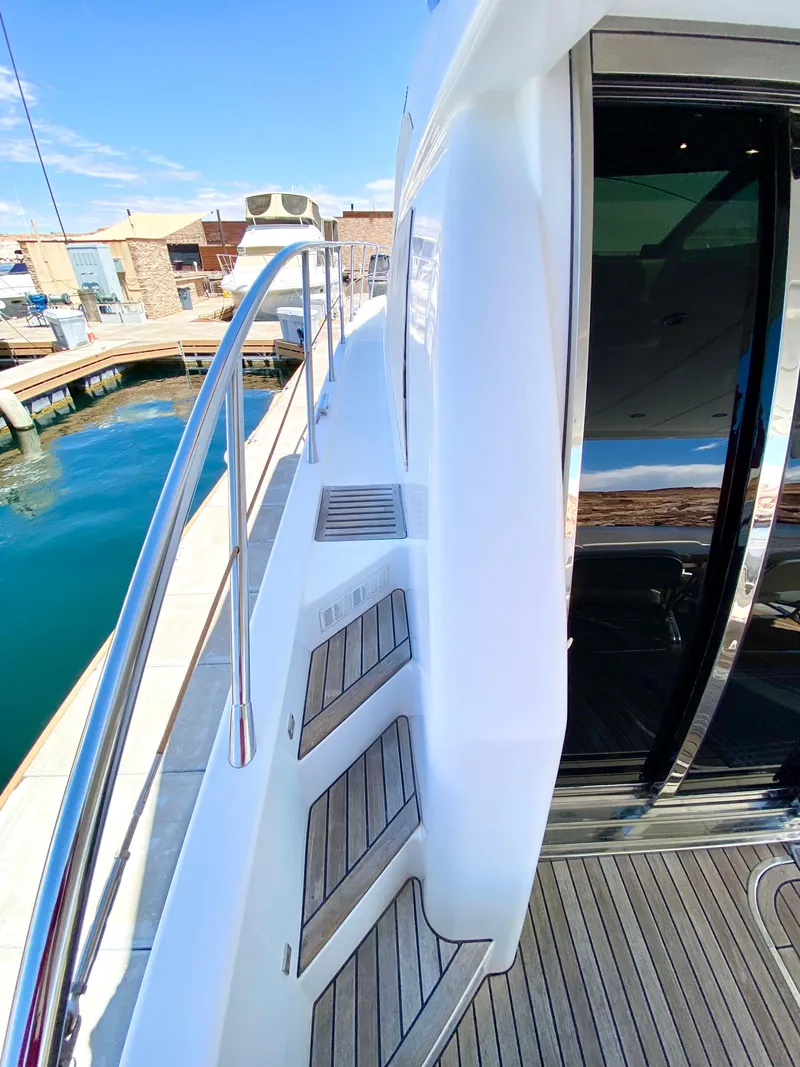 Slide: The Image of 2014 Dyna 52 yacht deck with sleek design and wooden steps. - 10
