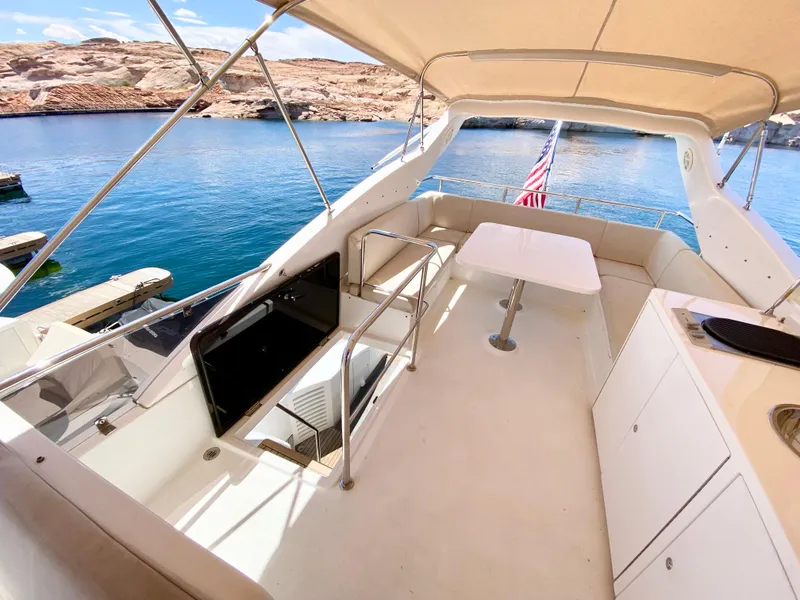 Slide: The Image of Luxurious 2014 Dyna 52 yacht interior with seating, table, and scenic water view. - 12