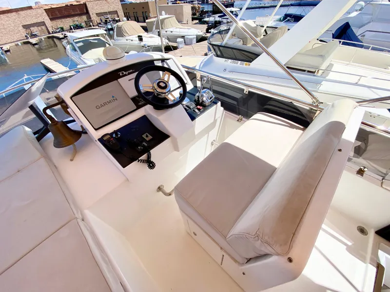 Slide: The Image of 2014 Dyna 52 yacht helm with Garmin navigation, docked at marina. - 15