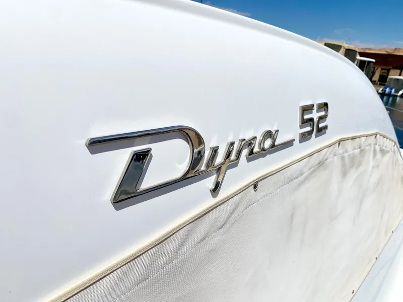 Slide: The Image of Close-up of 2014 Dyna 52 yacht logo on white surface. - 21